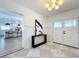 Open-concept entryway with marble-like tile, a modern light fixture, and a view into the open kitchen at 2520 Chanute Trl, Maitland, FL 32751