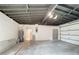 Spacious garage featuring block walls, overhead lighting, and an electric door opener at 2520 Chanute Trl, Maitland, FL 32751
