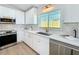 Well-lit kitchen featuring modern appliances, white cabinetry, and a stainless steel sink with a window at 2520 Chanute Trl, Maitland, FL 32751