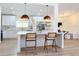 Bright kitchen island featuring a stone countertop, pendant lights, and an open-concept design for cooking at 2520 Chanute Trl, Maitland, FL 32751