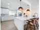 An airy kitchen with a large island, white cabinets, modern appliances, and seamless flow into other living areas at 2520 Chanute Trl, Maitland, FL 32751