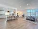 Bright, open living space with wood floors, a large island, and dining area near shuttered windows at 2520 Chanute Trl, Maitland, FL 32751