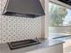 Elegant outdoor kitchen featuring patterned tile backsplash and modern grill with a view of the refreshing pool at 2520 Chanute Trl, Maitland, FL 32751