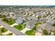 Wide aerial view of a well-planned community, showcasing homes with lush landscaping and streets at 2528 Buttonwood Run, The Villages, FL 32162