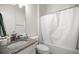 Bathroom featuring a granite-look vanity, toilet and tub with shower, and a white curtain at 2528 Buttonwood Run, The Villages, FL 32162