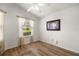 Bright bedroom with hardwood floors, natural light, ceiling fan, and neutral paint at 2528 Buttonwood Run, The Villages, FL 32162