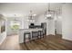 Modern kitchen featuring stainless steel appliances, stone countertops, and bar stool seating at 2528 Buttonwood Run, The Villages, FL 32162
