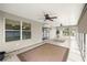 Enclosed patio featuring tile flooring, multiple ceiling fans, and screened windows at 2528 Buttonwood Run, The Villages, FL 32162