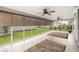 Bright sunroom featuring tile flooring, ceiling fans, and large windows offering beautiful backyard views at 2528 Buttonwood Run, The Villages, FL 32162
