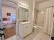 Bright bathroom with a white vanity, shower, and an open view to the bedroom at 2643 Aloma Oaks Dr, Oviedo, FL 32765