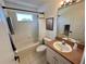 Bathroom with a tub/shower combination and a single sink vanity and window at 2643 Aloma Oaks Dr, Oviedo, FL 32765