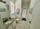 Bathroom with granite counter, a framed boat image, and walkout to outdoor patio at 2643 Aloma Oaks Dr, Oviedo, FL 32765