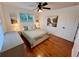 Bedroom with hardwood floors, modern lighting, and a peaceful outdoor view at 2643 Aloma Oaks Dr, Oviedo, FL 32765