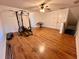 Large, versatile bonus room with hardwood floors, gym equipment, and a keyboard at 2643 Aloma Oaks Dr, Oviedo, FL 32765