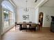 Elegant dining room featuring a large window, hardwood floors, and decorative chandelier at 2643 Aloma Oaks Dr, Oviedo, FL 32765