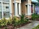 Inviting front entrance with decorative columns, lush landscaping, and charming curb appeal at 2643 Aloma Oaks Dr, Oviedo, FL 32765