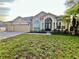 Charming one-story home with an attached garage, well-maintained lawn, and inviting curb appeal at 2643 Aloma Oaks Dr, Oviedo, FL 32765