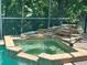 A unique hot tub and water feature, located in the screened pool area at 2643 Aloma Oaks Dr, Oviedo, FL 32765