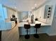 Stylish kitchen with white cabinets, stainless steel appliances, quartz counters, and breakfast bar at 2643 Aloma Oaks Dr, Oviedo, FL 32765