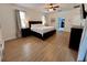 Comfortable main bedroom featuring hardwood floors, neutral decor, and ample natural light at 2643 Aloma Oaks Dr, Oviedo, FL 32765
