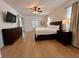 Bright main bedroom with hardwood floors, ceiling fan, and views into an adjacent office at 2643 Aloma Oaks Dr, Oviedo, FL 32765