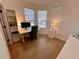 Bright home office features a sleek desk, comfortable chair, and a window with a view of the pool at 2643 Aloma Oaks Dr, Oviedo, FL 32765