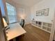 Bright office space with hardwood floors, a built-in shelf, and ample natural light at 2643 Aloma Oaks Dr, Oviedo, FL 32765
