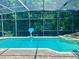 Sparkling pool with connected spa surrounded by a screened enclosure and lush greenery at 2643 Aloma Oaks Dr, Oviedo, FL 32765