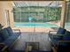 Screened pool area with covered patio and beautiful blue outdoor seating at 2643 Aloma Oaks Dr, Oviedo, FL 32765