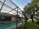 Back yard with a screened in pool and seating at 2643 Aloma Oaks Dr, Oviedo, FL 32765