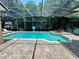 Enjoy this screened pool with a basketball hoop and a relaxing waterfall spa at 2643 Aloma Oaks Dr, Oviedo, FL 32765