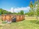 Above ground pool with a ladder, pump, and a small shelf for pool accessories, perfect for summer fun at 2771 Ne 66Th St, Ocala, FL 34479