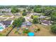 Aerial view showcasing a residential neighborhood with mature trees and well-maintained homes at 2771 Ne 66Th St, Ocala, FL 34479