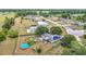 A neighborhood aerial view featuring mature trees, residences with solar panels, and above-ground pools at 2771 Ne 66Th St, Ocala, FL 34479