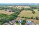 Aerial view of residences with large yards, mature trees, inground pool, and solar panels at 2771 Ne 66Th St, Ocala, FL 34479