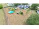Aerial view of a home with a large backyard, above-ground pool, and screened in porch at 2771 Ne 66Th St, Ocala, FL 34479