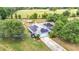 This aerial view highlights solar panels and a spacious fenced yard with a pool and trampoline at 2771 Ne 66Th St, Ocala, FL 34479