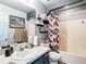 Bathroom featuring a sink, toilet, and tub-shower combo with decorative shower curtain at 2771 Ne 66Th St, Ocala, FL 34479