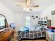 Bedroom with wood floor, lots of natural light, a dresser, and decorative items at 2771 Ne 66Th St, Ocala, FL 34479