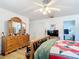 Spacious bedroom shows natural light, with an attached bathroom view, plus a white door and TV at 2771 Ne 66Th St, Ocala, FL 34479