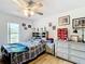 Bedroom featuring wood floors, a ceiling fan, natural light, and storage shelves at 2771 Ne 66Th St, Ocala, FL 34479