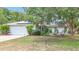 Charming single-story home with a two-car garage, solar panels, seating, and a well-manicured lawn at 2771 Ne 66Th St, Ocala, FL 34479