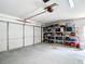 View of the spacious garage with shelving, providing ample storage and organization options at 2771 Ne 66Th St, Ocala, FL 34479