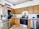 Functional kitchen featuring stainless steel appliances and oak cabinets at 2771 Ne 66Th St, Ocala, FL 34479