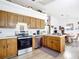Open kitchen with stainless steel appliances and oak cabinets adjacent to dining area at 2771 Ne 66Th St, Ocala, FL 34479