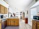 Functional kitchen with oak cabinets and stainless steel appliances adjacent to dining area at 2771 Ne 66Th St, Ocala, FL 34479
