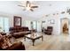 Spacious living room featuring comfortable seating, ceiling fan, decor, and hardwood floors at 2771 Ne 66Th St, Ocala, FL 34479