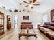 Comfortable living room with a ceiling fan, hardwood floors, and decorations on the high shelf at 2771 Ne 66Th St, Ocala, FL 34479