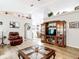 Inviting living room with hardwood floors, ceiling fan, and decorative decor, with a view of the dining room at 2771 Ne 66Th St, Ocala, FL 34479