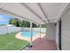 Covered back patio provides shade and outdoor living space adjacent to the backyard swimming pool at 2835 Bongart Rd, Winter Park, FL 32792